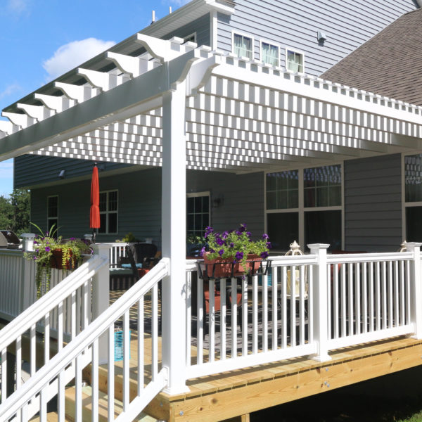 White vinyl deck railing with attached pergola