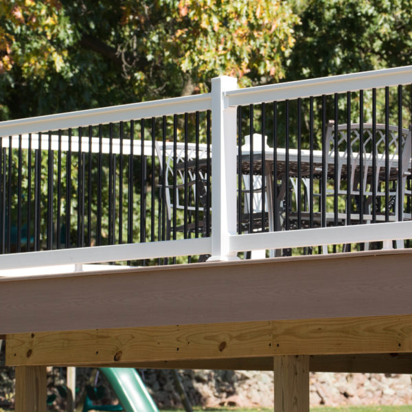 White and black vinyl deck railing with brown deck