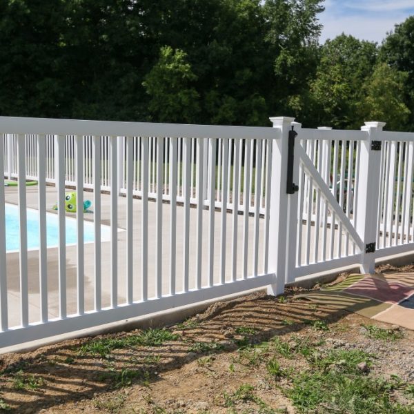 Pool with white vinyl fence and gate