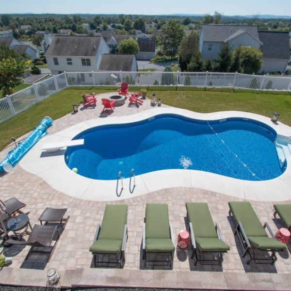 Large pool surrounded by white vinyl fencing