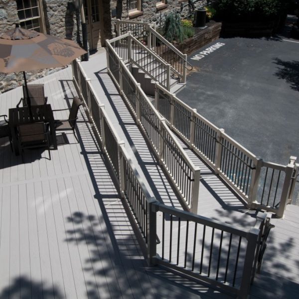 Wheel chair ramp with tan vinyl guide rails