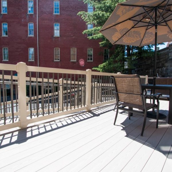 Large deck and ramp with tan vinyl railings