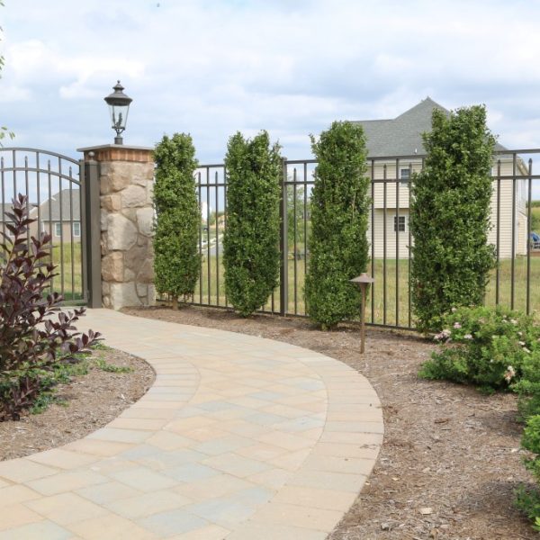 Brown Aluminum Regis Yard Fencing with Stone Pillars