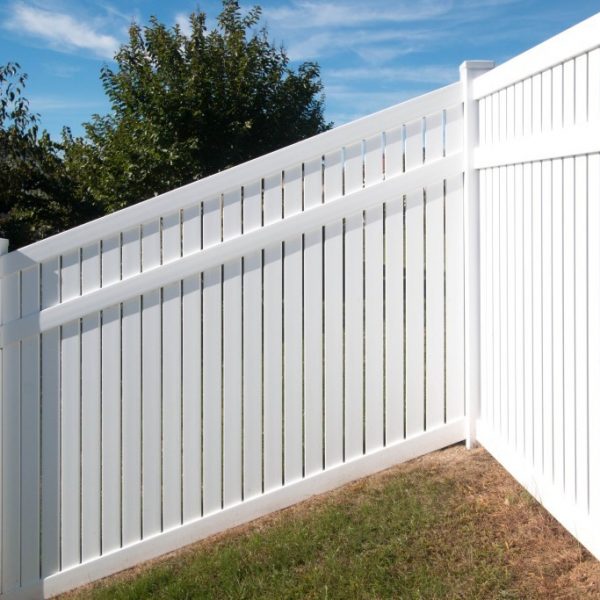 Sloped white vinyl fence