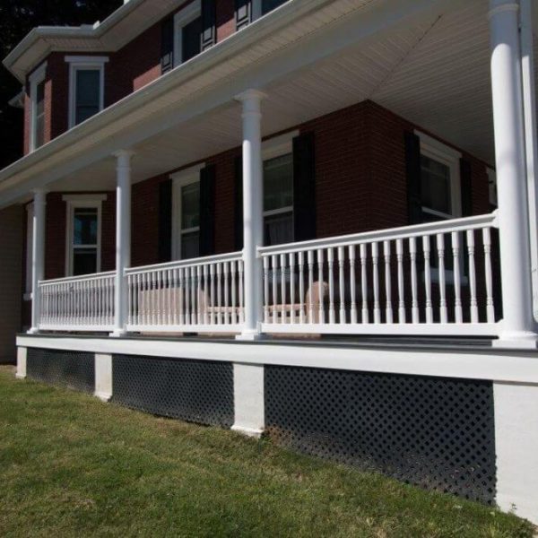 Brick house with covered front porch with white vinyl railings