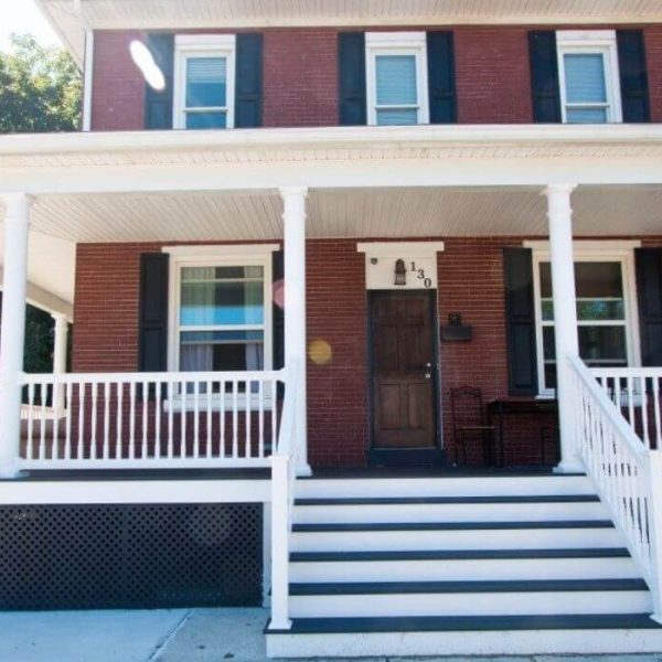 Red brick house with white vinyl porch rails