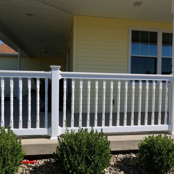 Covered Concrete Porch with White Vinyl Railings