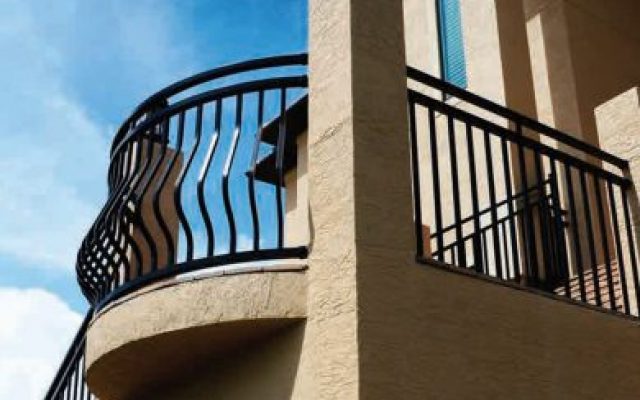 Black aluminum railing around a veranda of a stucco house