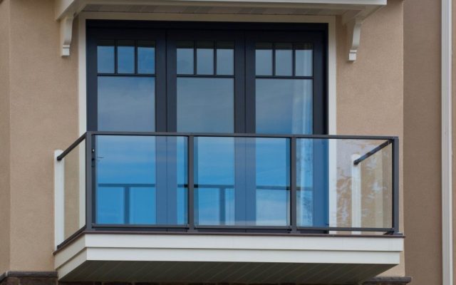 An aluminum and glass railing on a veranda