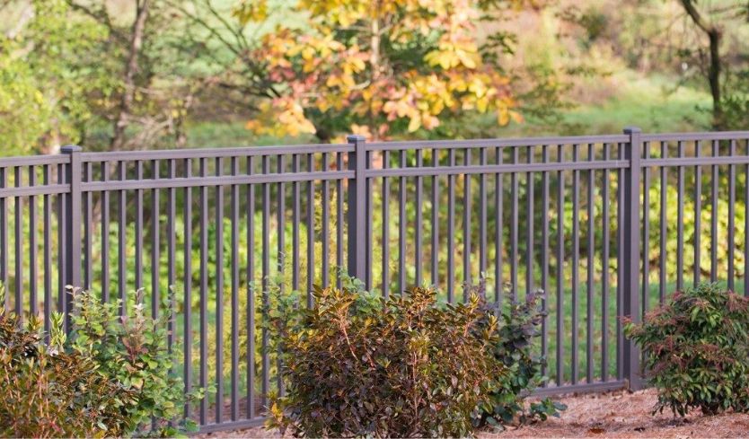 Chocolate colored aluminum fence style against fall landscaping