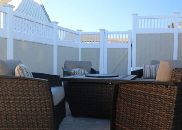 tan and white vinyl privacy fence around outdoor seating area