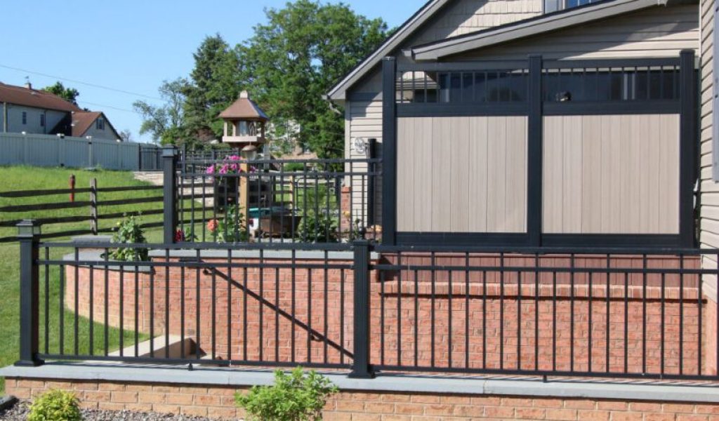 Wood colored vinyl fence with black aluminum fencing