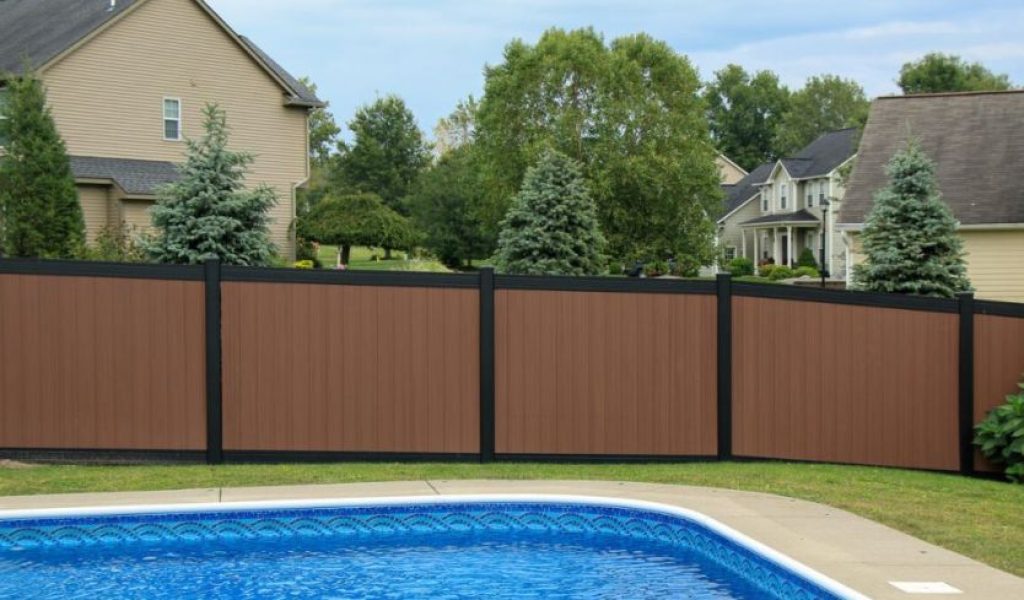 Wood look vinyl fence surrounding pool for privacy