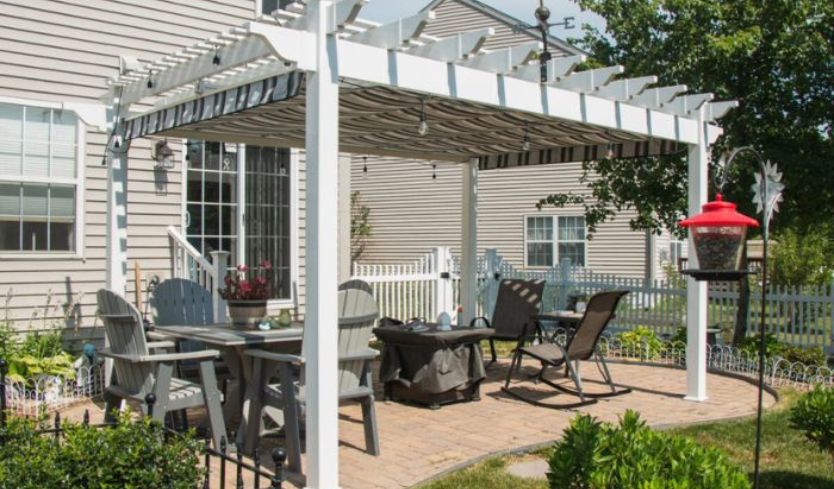 Outdoor seating area with vinyl pergola