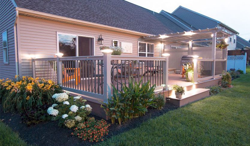 Backyard sitting area at dusk with lights