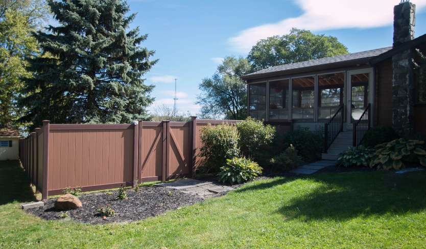 Brown vinyl fence with dark brown trim 