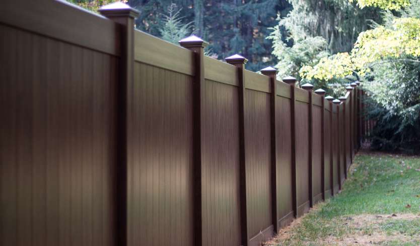 Dark brown vinyl fence for privacy in yard